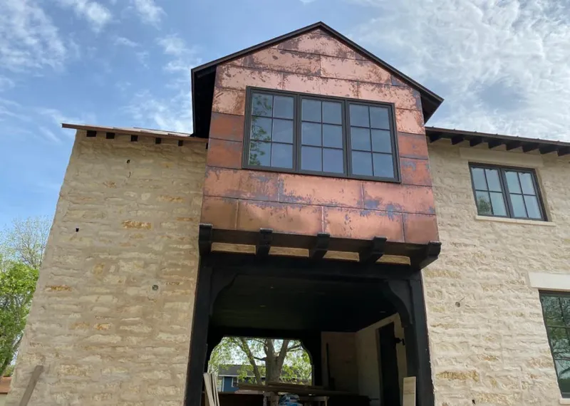 Copper metal panel facade on a stone building for Skylight Installation in Mebane